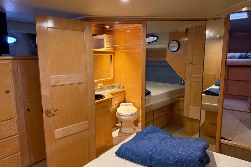 Slide: The Image of Interior of 1999 Navigator 5300 yacht with wooden cabinetry and compact bathroom. - 42