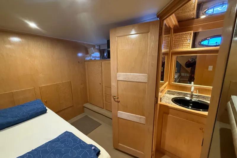 Slide: The Image of Cozy 1999 Navigator 5300 yacht cabin with wood paneling and ensuite bathroom. - 43