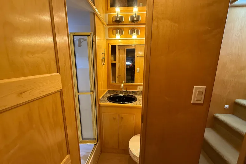 Slide: The Image of 1999 Navigator 5300 yacht bathroom with wooden cabinetry, sink, and shower. - 48