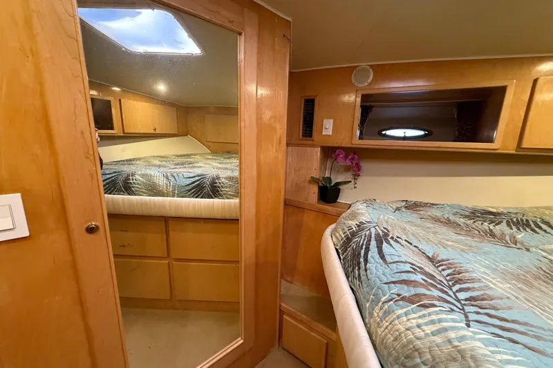 Slide: The Image of Cozy bedroom in 1999 Navigator 5300 yacht with wood cabinetry and floral bedding. - 49