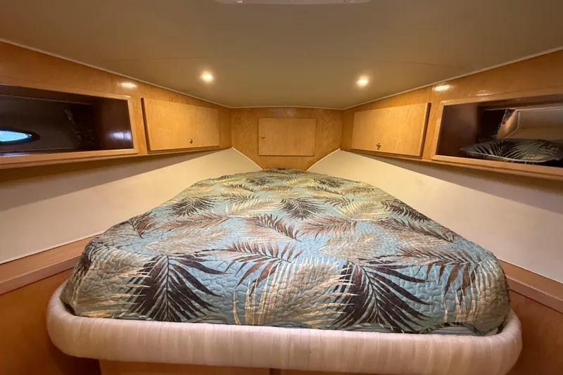 Slide: The Image of Cozy cabin bedroom in 1999 Navigator 5300 yacht with tropical-themed bedding. - 50
