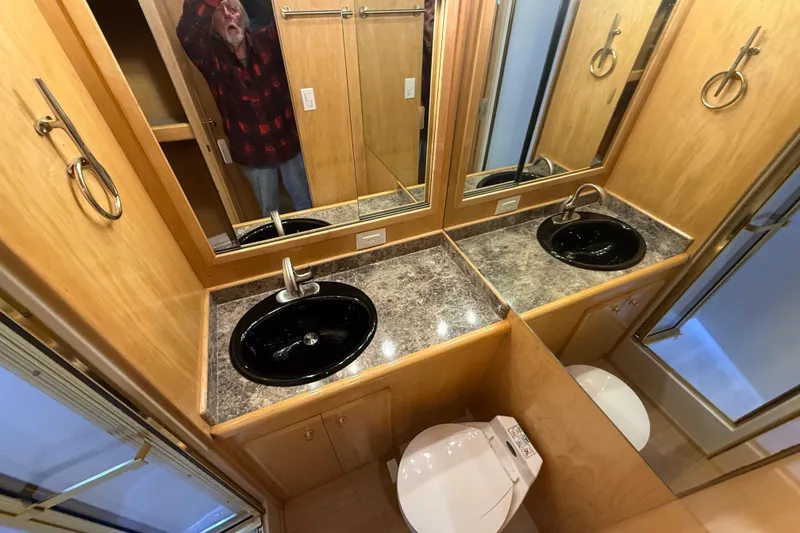 Slide: The Image of Bathroom interior of 1999 Navigator 5300 with dual sinks and mirrors. - 52
