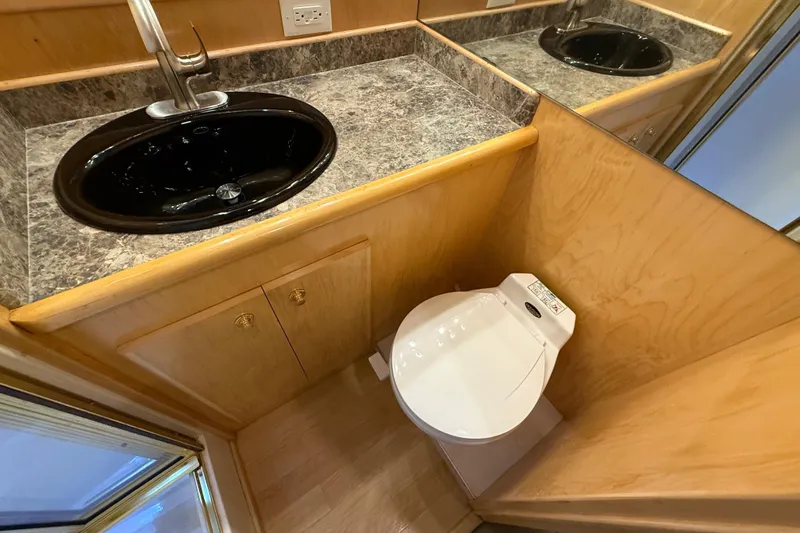 Slide: The Image of Compact bathroom in 1999 Navigator 5300 with black sink and modern toilet. - 53
