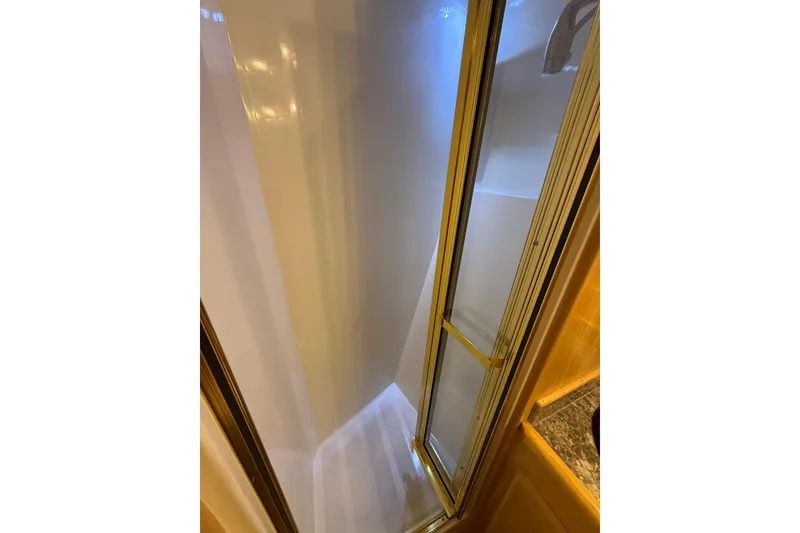 Slide: The Image of Shower area inside 1999 Navigator 5300 yacht with glass door and white interior. - 54