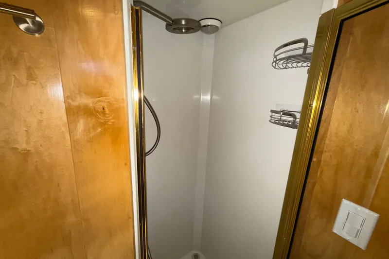 Slide: The Image of Shower area in 1999 Navigator 5300 with wooden door and metal fixtures. - 55