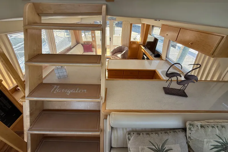 Slide: The Image of Interior of 1999 Navigator 5300 yacht with elegant wooden stairs and cozy living area. - 60