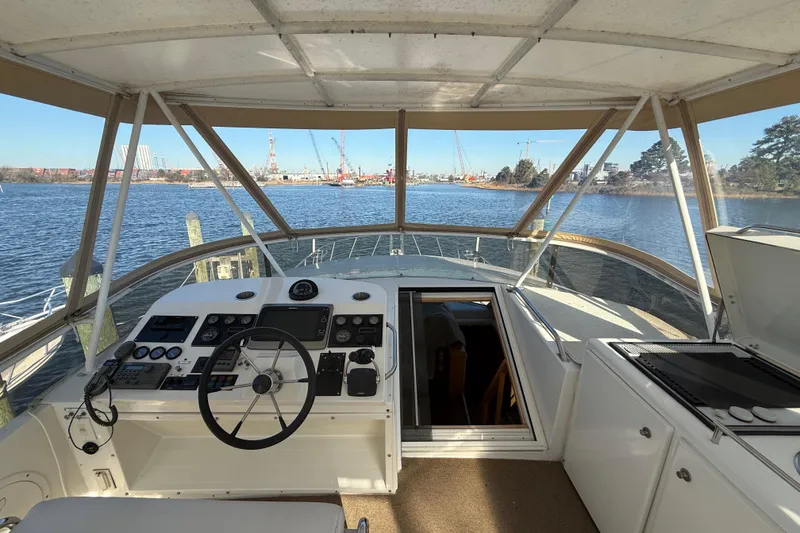 Slide: The Image of 1999 Navigator 5300 yacht helm with panoramic water view and control panel. - 61