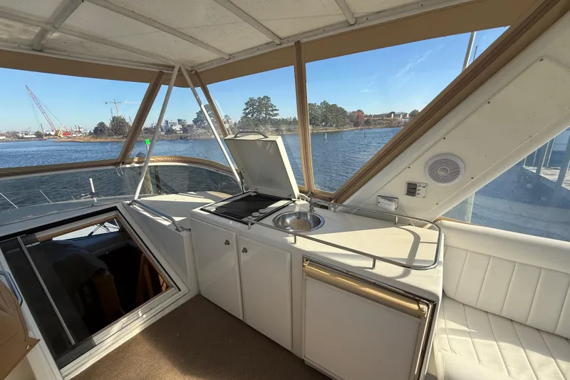 Slide: The Image of Interior view of 1999 Navigator 5300 yacht with kitchenette and waterway backdrop. - 62