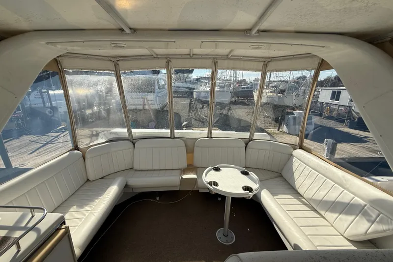 Slide: The Image of Interior view of 1999 Navigator 5300 yacht with white seating and round table. - 65