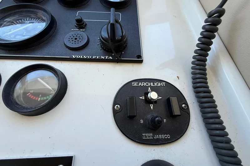 Slide: The Image of Control panel of a 1999 Navigator 5300 with Volvo Penta gauges and Jabsco searchlight controls. - 67