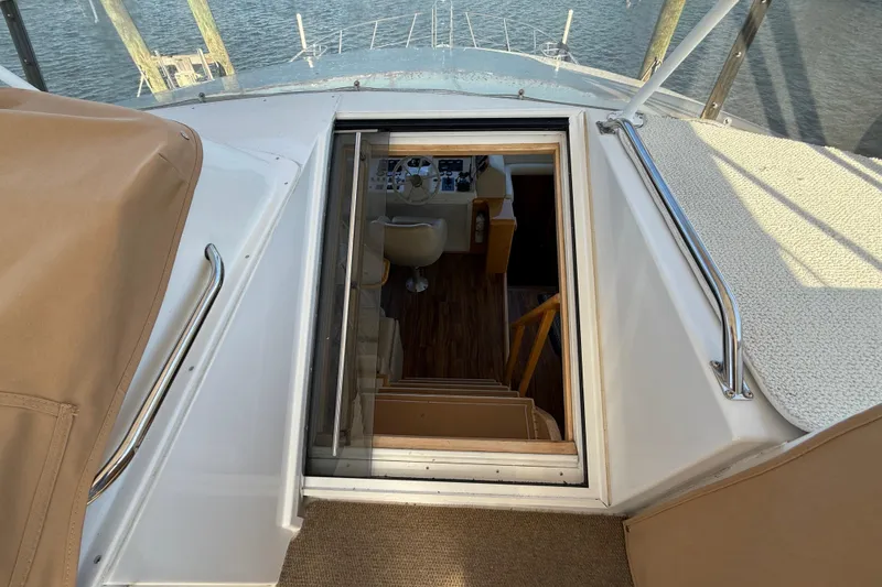Slide: The Image of Stairway view inside 1999 Navigator 5300 yacht, overlooking helm and water. - 68