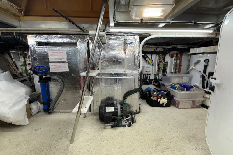 Slide: The Image of Engine room of a 1999 Navigator 5300 yacht with equipment and storage. - 74