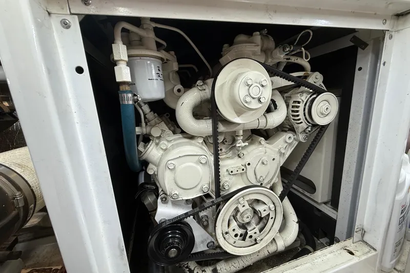 Slide: The Image of Engine compartment of a 1999 Navigator 5300, showcasing mechanical components and belts. - 79