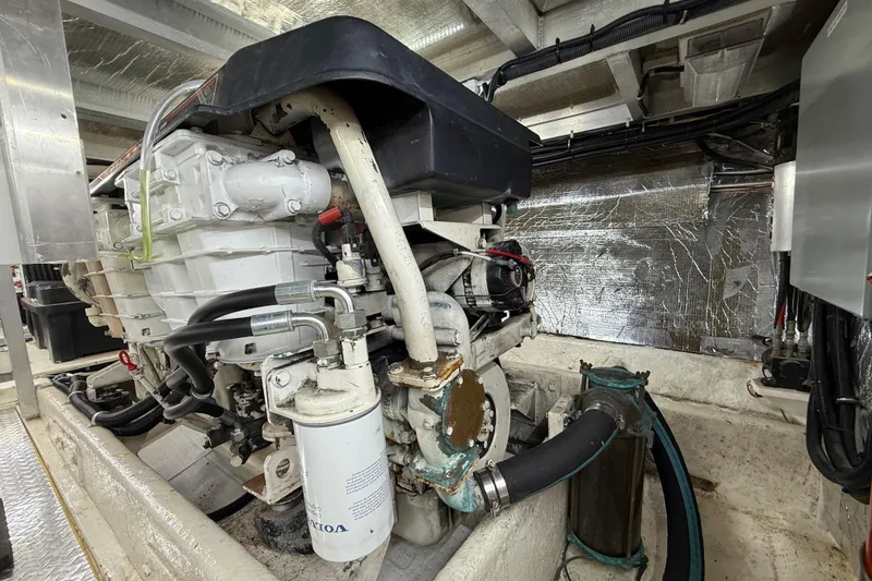 Slide: The Image of Engine room of a 1999 Navigator 5300 yacht, showcasing mechanical components. - 86