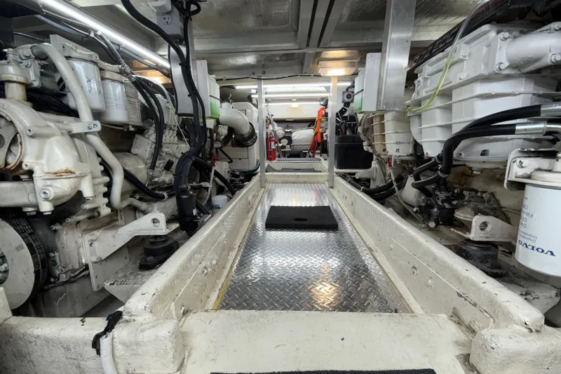 Slide: The Image of Engine room of a 1999 Navigator 5300 yacht, featuring dual engines and metallic flooring. - 89