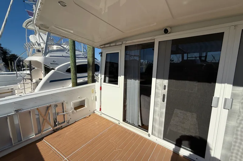 Slide: The Image of 1999 Navigator 5300 yacht deck with sliding glass doors and wooden flooring. - 9