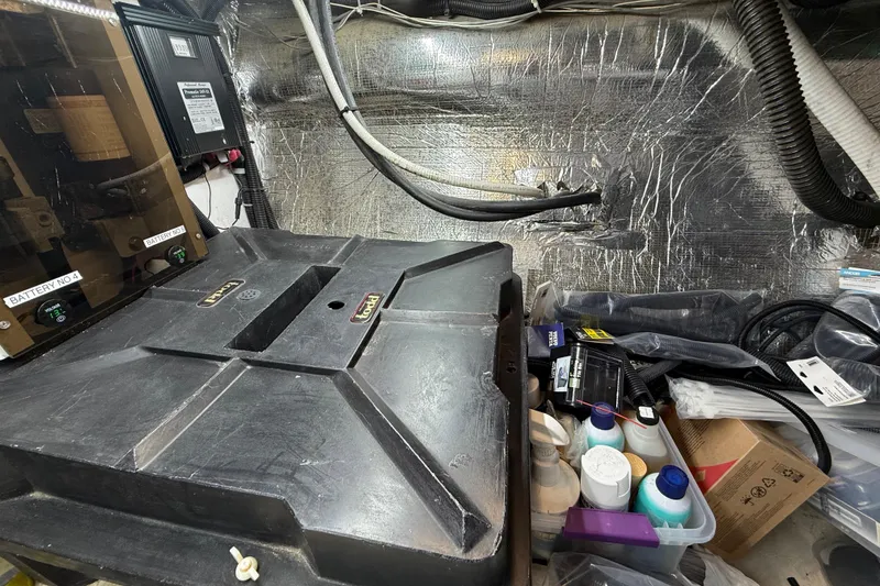 Slide: The Image of 1999 Navigator 5300 engine room with batteries, cables, and maintenance supplies. - 93