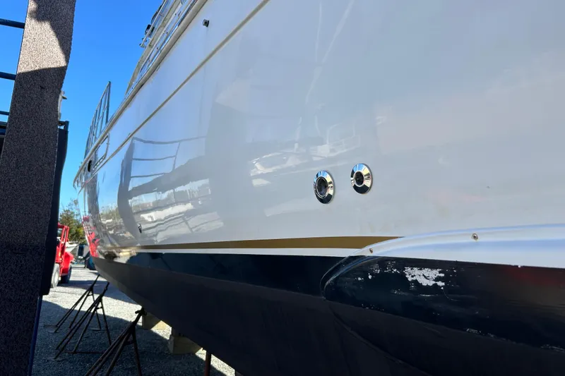 Slide: The Image of 1999 Navigator 5300 yacht on dry dock, showcasing sleek hull design. - 97