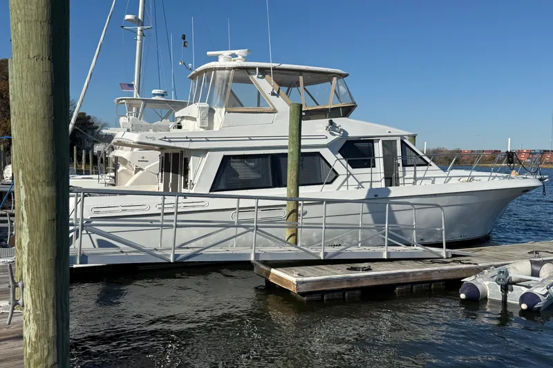 The Image of 1999 Navigator 5300 yacht docked at marina under clear blue sky. - 0