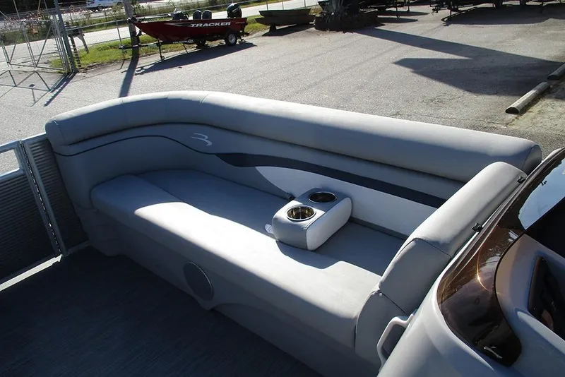 Slide: The Image of 2022 Bennington 20 SSR pontoon boat interior with gray seating and cup holders. - 10