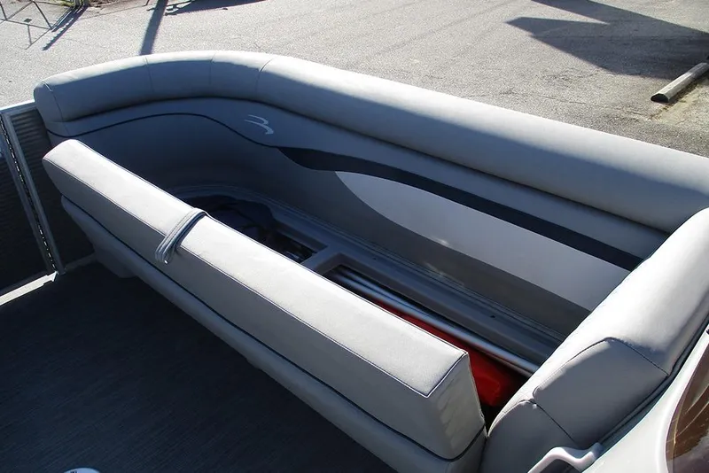 Slide: The Image of 2022 Bennington 20 SSR boat interior with gray seating and storage compartment. - 11