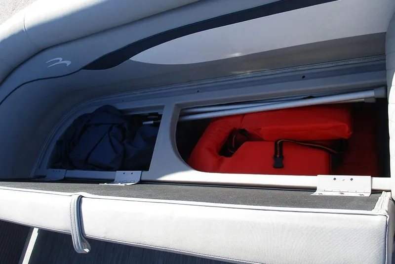 Slide: The Image of Storage compartment in a 2022 Bennington 20 SSR boat with life jackets and gear. - 12