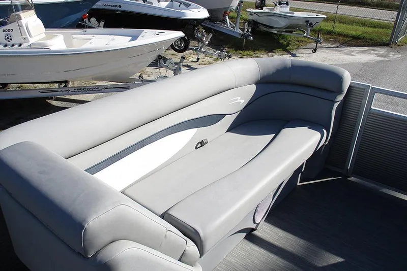 Slide: The Image of 2022 Bennington 20 SSR pontoon boat with gray seating, docked near other boats. - 13