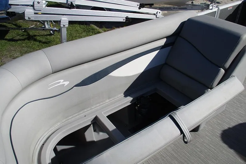 Slide: The Image of 2022 Bennington 20 SSR pontoon boat interior with gray seating and storage compartment. - 17