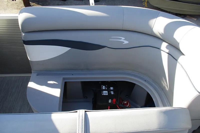 Slide: The Image of 2022 Bennington 20 SSR boat seat with storage compartment open, revealing battery. - 20