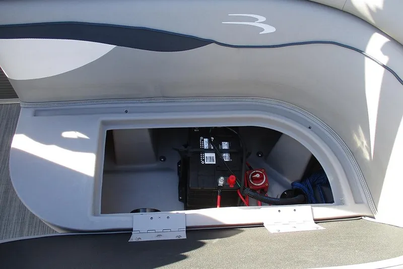 Slide: The Image of 2022 Bennington 20 SSR boat battery compartment with visible wiring and storage space. - 21