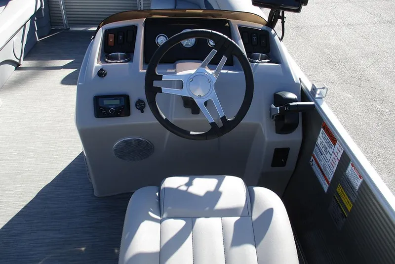 Slide: The Image of 2022 Bennington 20 SSR boat helm with steering wheel and control panel. - 22
