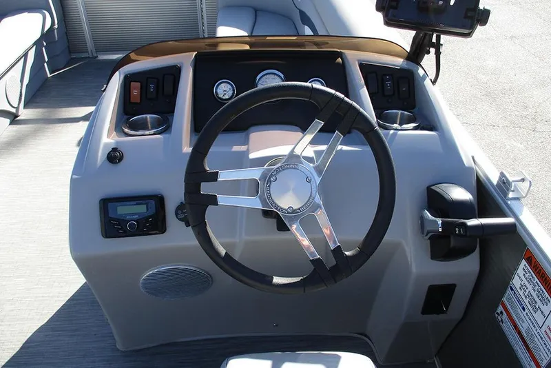 Slide: The Image of 2022 Bennington 20 SSR boat dashboard with steering wheel and control panel. - 23