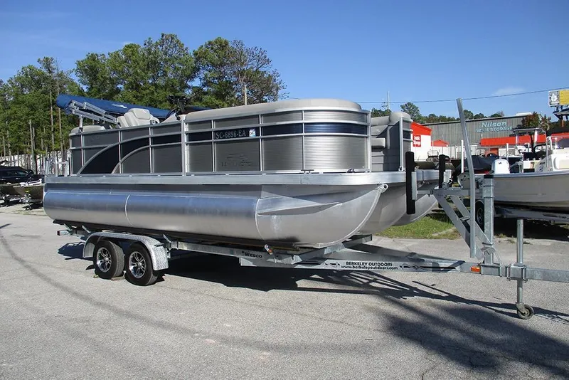 Slide: The Image of 2022 Bennington 20 SSR pontoon boat on trailer in outdoor setting. - 3