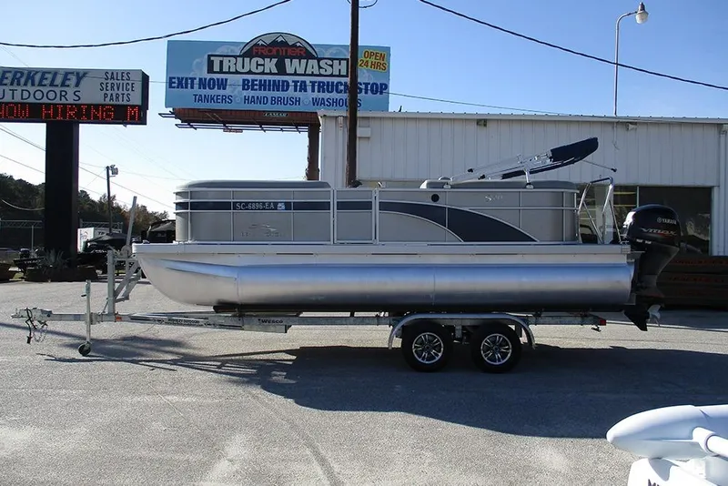 Slide: The Image of 2022 Bennington 20 SSR pontoon boat on trailer at dealership. - 6