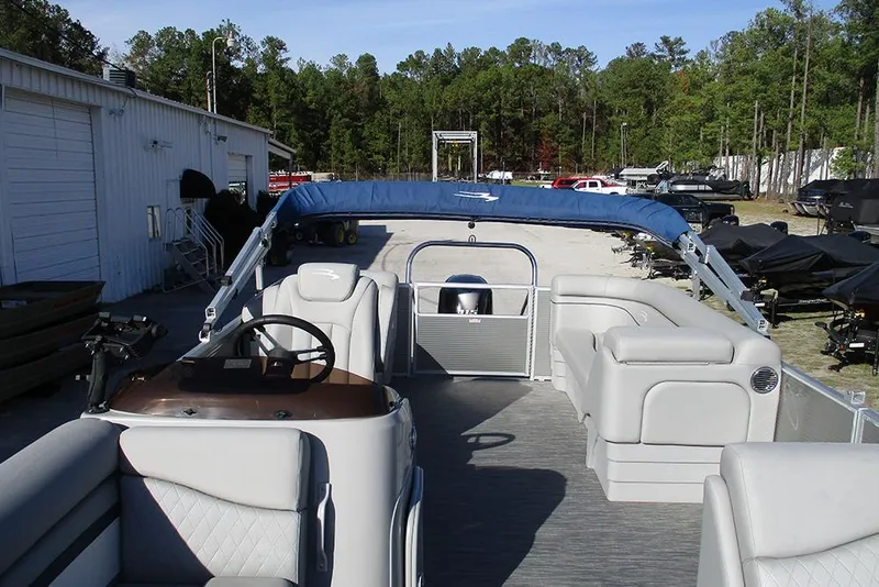 Slide: The Image of 2022 Bennington 20 SSR pontoon boat with spacious seating and canopy in a marina setting. - 8