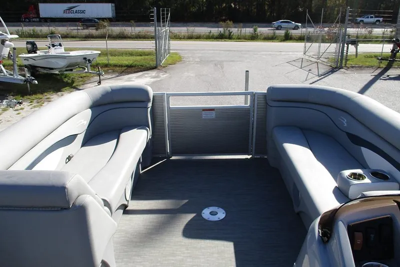 Slide: The Image of 2022 Bennington 20 SSR pontoon boat interior with gray seating and open gate. - 9