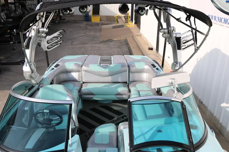 Slide: The Image of 2014 Master Craft X-Star boat interior with teal and gray seating, featuring a sleek design. - 18