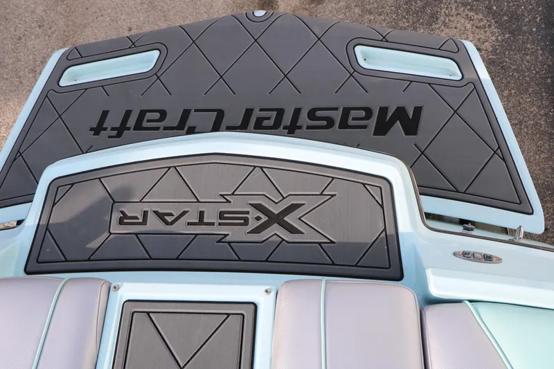 Slide: The Image of 2014 Master Craft X-Star boat deck with logo and cushioned seating. - 20