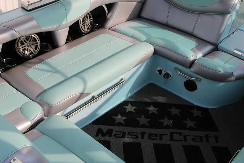 Slide: The Image of 2014 Master Craft X-Star interior with teal and gray seating, featuring premium speakers. - 25