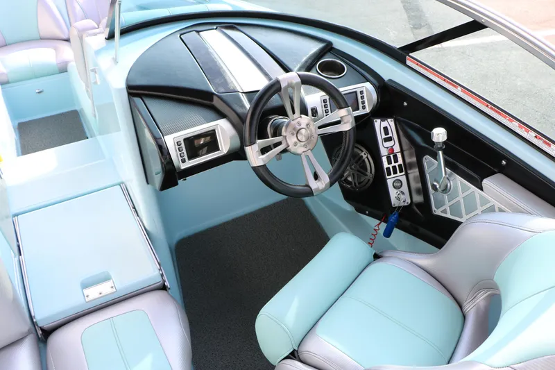 Slide: The Image of Interior of a 2014 Master Craft X-Star boat with modern steering and controls. - 26