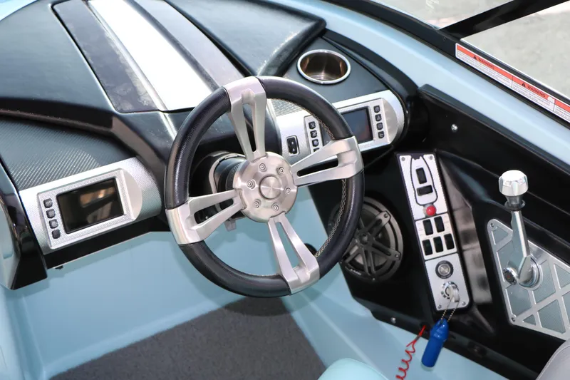 Slide: The Image of 2014 Master Craft X-Star boat dashboard with steering wheel and control panel. - 27