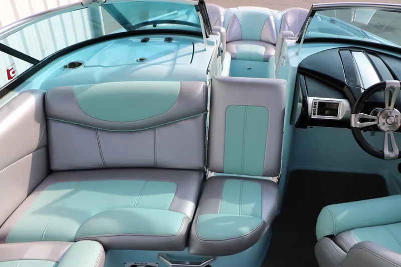 Slide: The Image of 2014 Master Craft X-Star interior with teal and gray seating, modern dashboard, and steering wheel. - 28