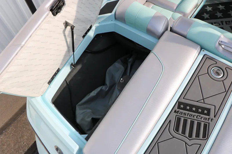Slide: The Image of 2014 Master Craft X-Star boat storage compartment with open lid and branded interior. - 32
