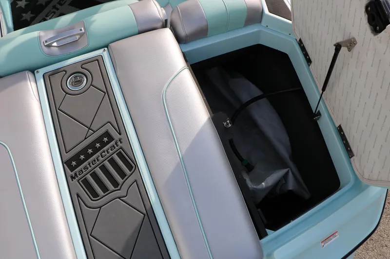Slide: The Image of 2014 Master Craft X-Star boat interior storage compartment with open lid. - 33