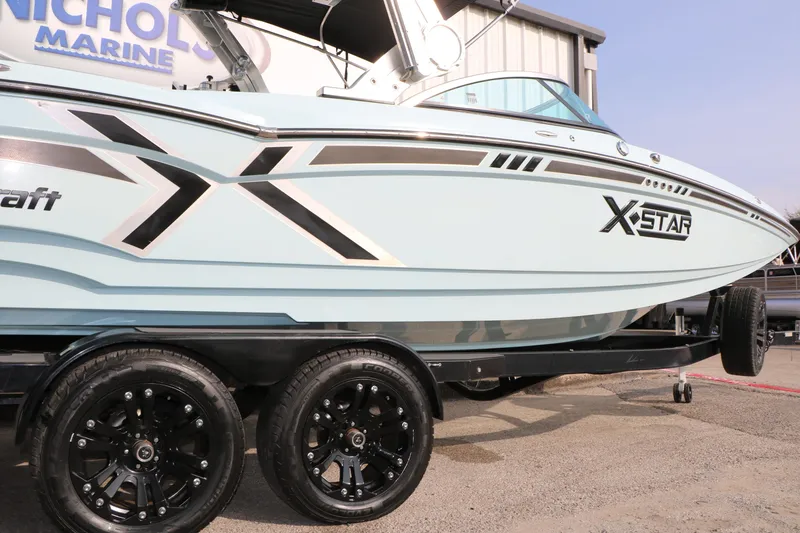 Slide: The Image of 2014 Master Craft X-Star boat on trailer, side view with stylish graphics. - 44