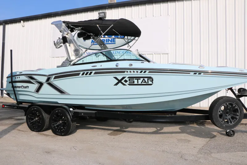 Slide: The Image of 2014 Master Craft X-Star boat on trailer, light blue with black accents. - 45