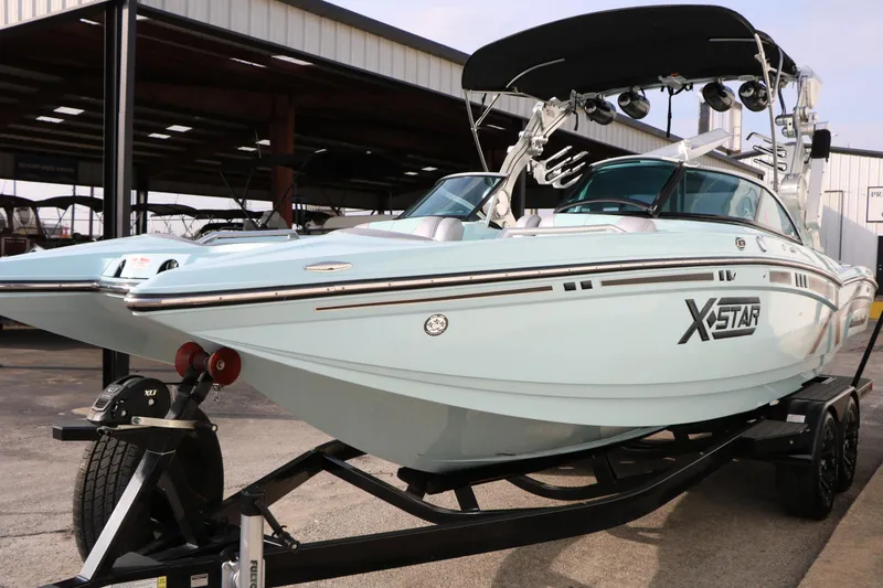 Slide: The Image of 2014 Master Craft X-Star boat on trailer, light blue, under covered storage. - 7