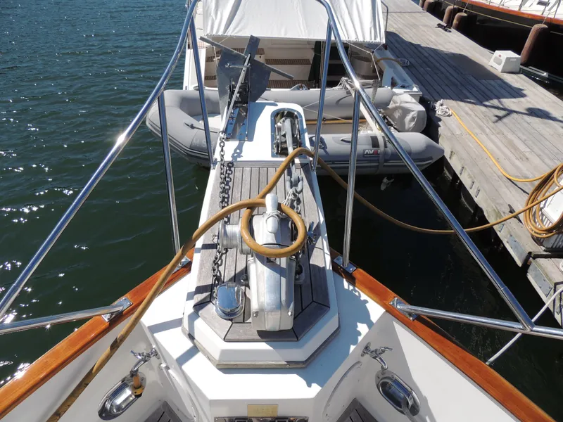 Slide: The Image of Bow view of 2002 Grand Banks 42 Classic yacht docked with dinghy. - 17