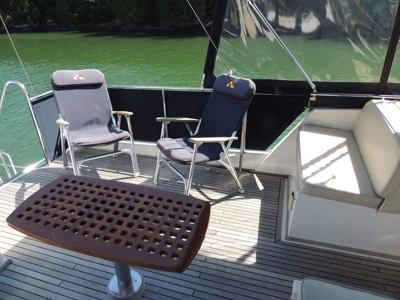 Slide: The Image of Deck of 2002 Grand Banks 42 Classic with chairs and table, overlooking water. - 36