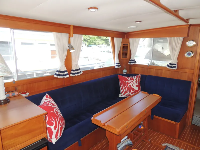Slide: The Image of Interior of 2002 Grand Banks 42 Classic yacht with blue seating and nautical decor. - 40